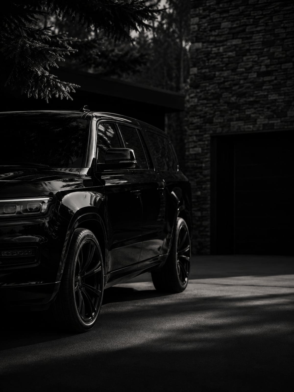 Black SUV at a stone-walled Prior Lake driveway