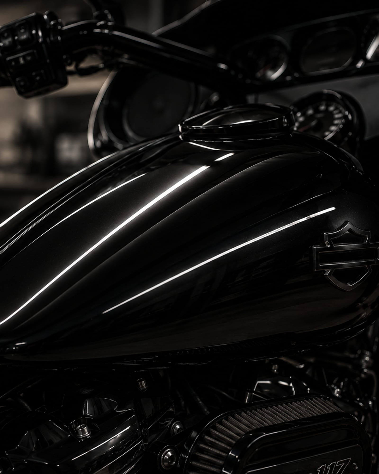 Chrome and tank detail on a motorcycle in low light